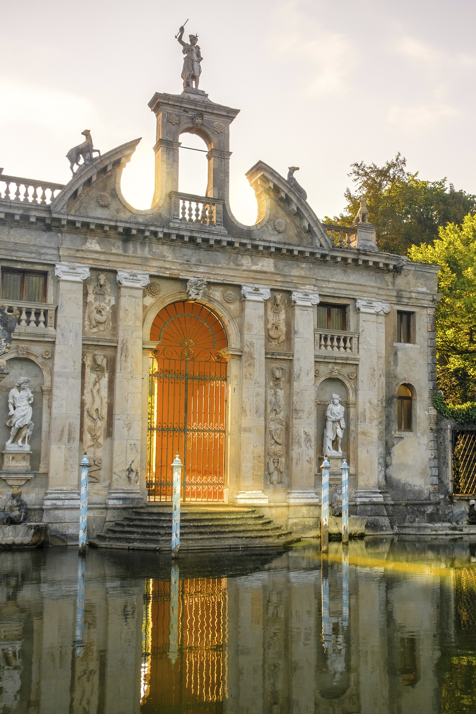sun rays pass through the gates of Valsanzibio garden on water p