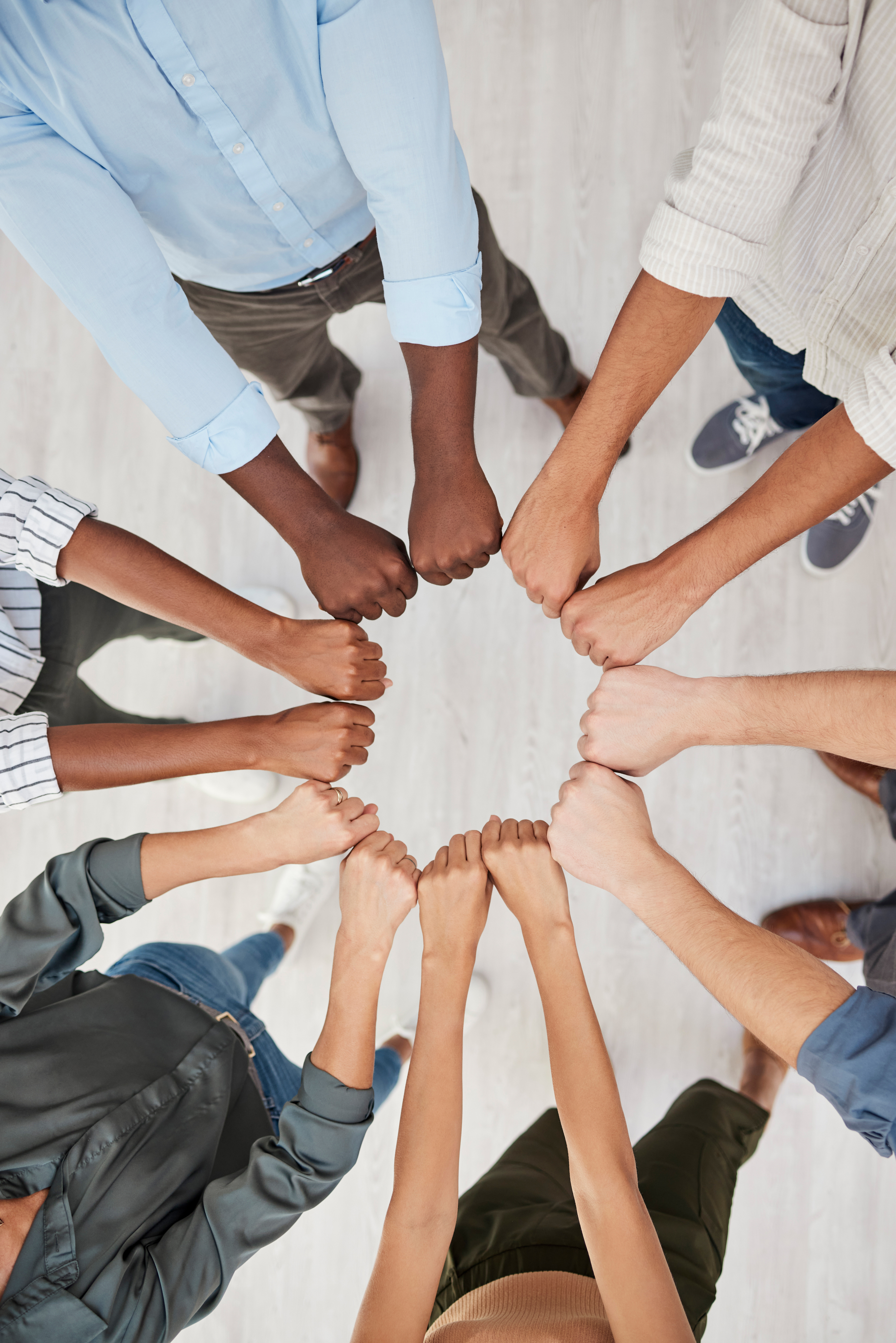 Team building, fist and hands in support of motivation circle by colleagues show community, trust and diversity above. Hand, people and collaboration with team in huddle for goal, mission and vision